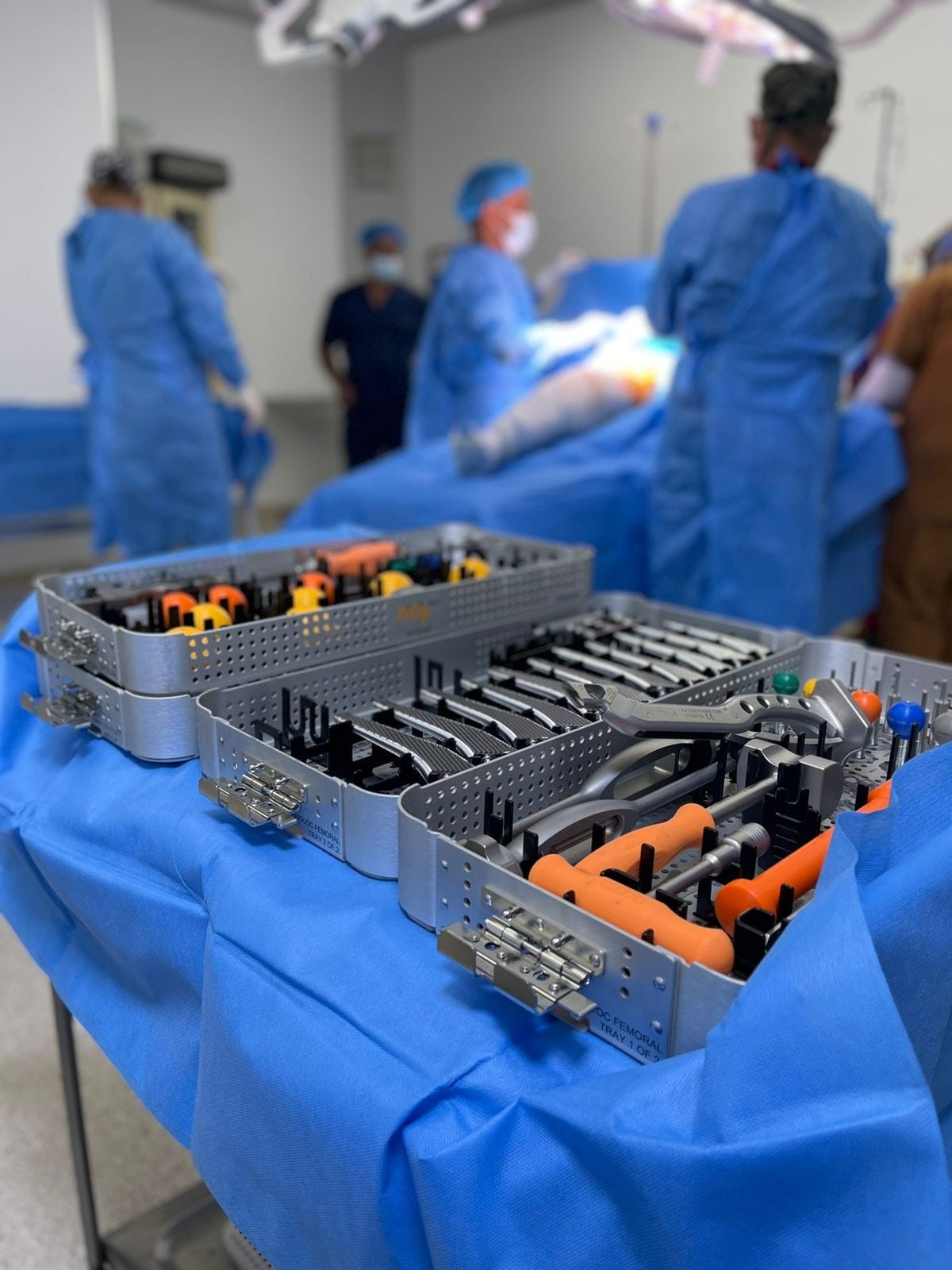 aap Joints implants and instruments in the operation room with surgeons and patient, for a joint reconstruction hip surgery.